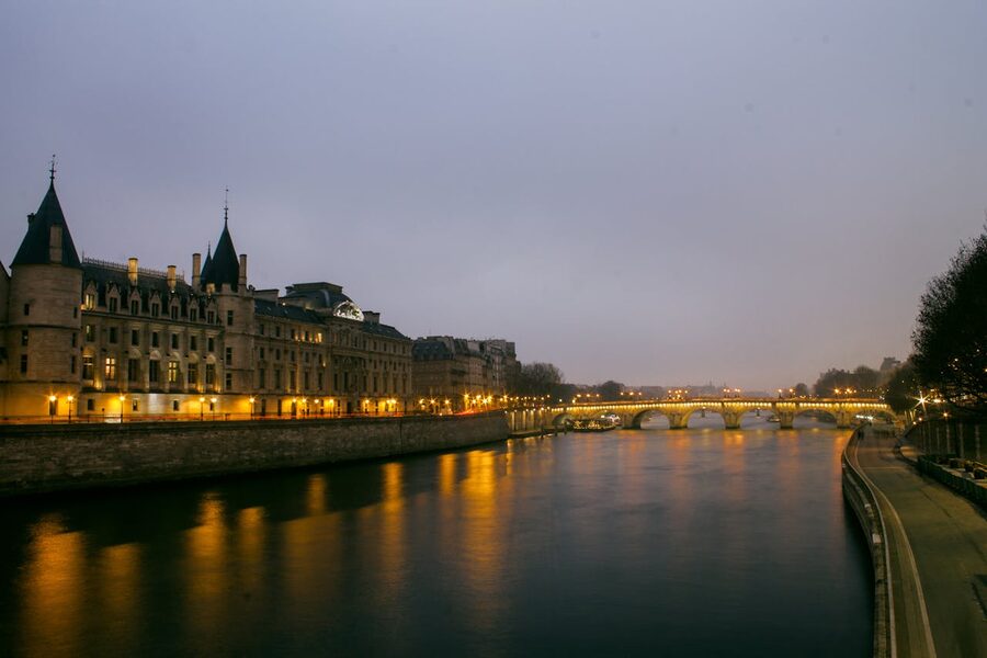 Dusk over the Seine River with historic Parisian architecture and bridge reflections