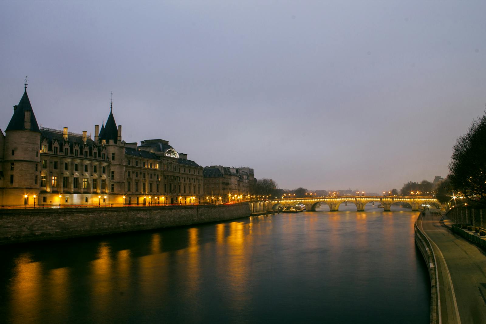 Seine River at dusk with Paris bridge and architecture reflections
