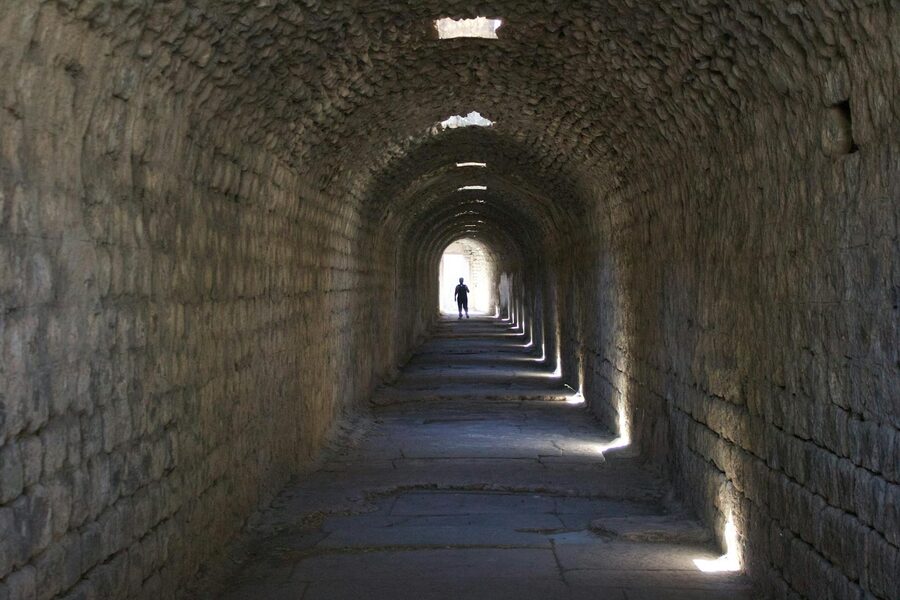 Silhouette in an ancient stone corridor