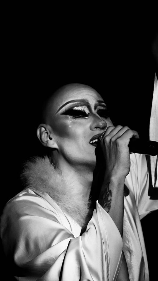 Singer passionately performing with microphone in monochrome