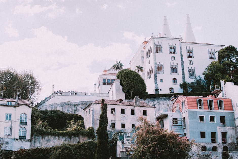 Colorful facade of Pena Palace rising above the trees in Sintra