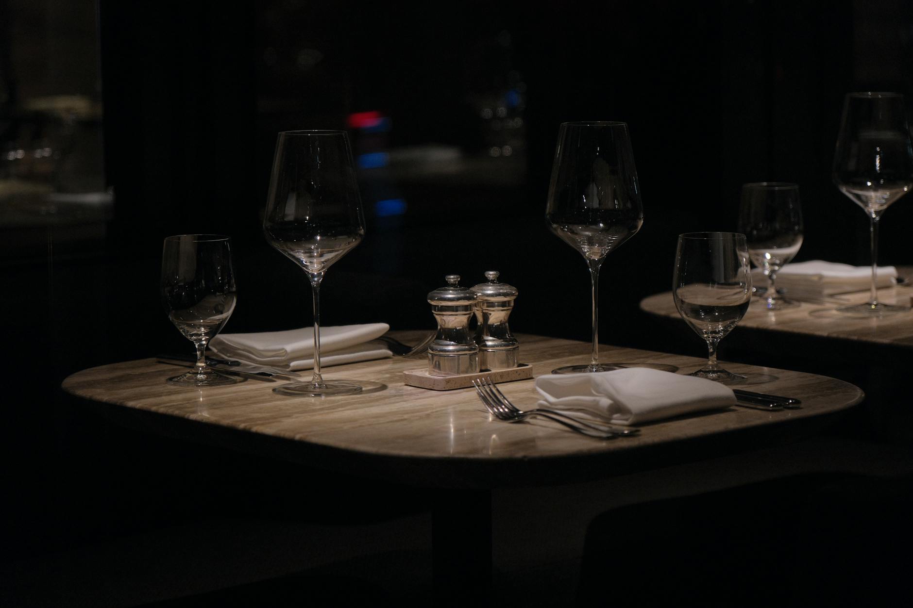 A sophisticated restaurant table setting with wine glasses and cutlery