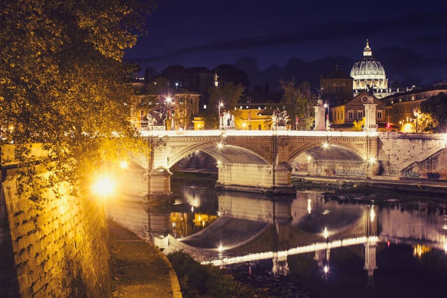 St Peters Basilica at night over Tiber bridge