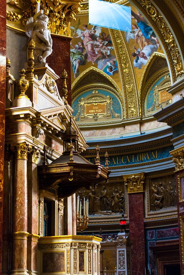 The ornate interior of St Stephens Basilica in Budapest showing the main nave marble columns and altar