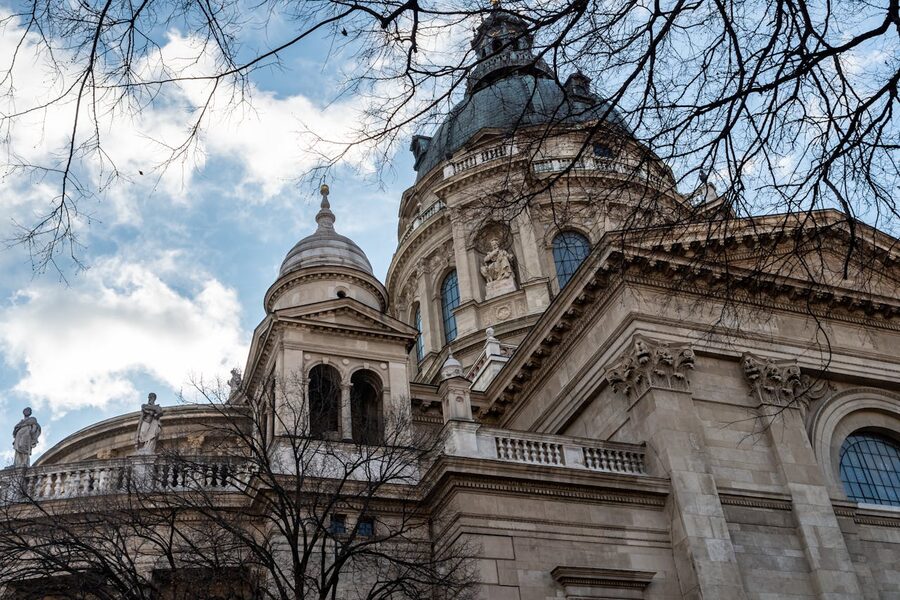 Low angle shot of St Stephens Basilica facade in Budapest showing the grand columns and dome against the sky