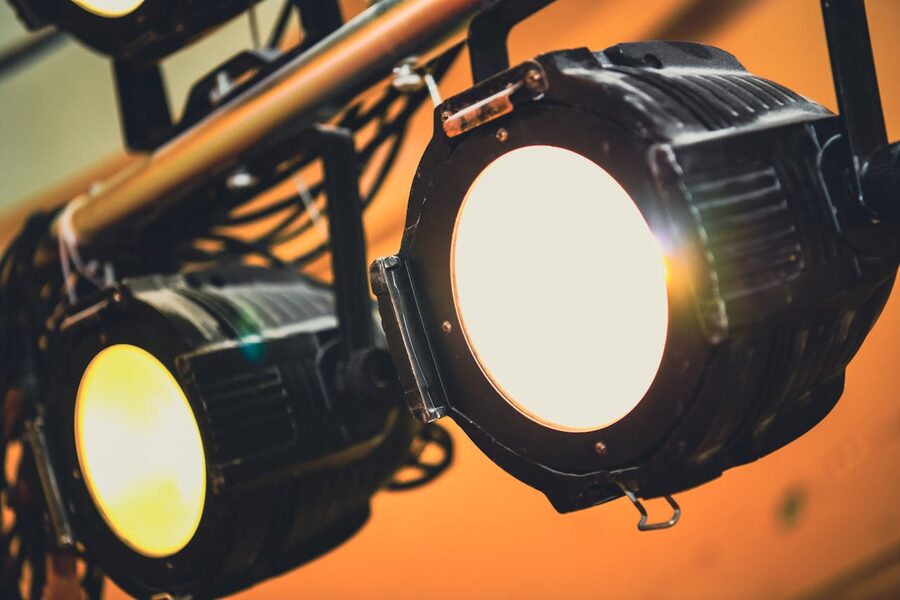 Stage spotlights casting soft warm light
