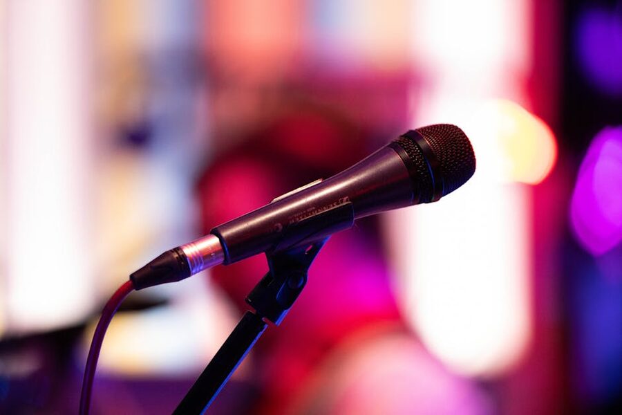 Stand-up microphone on stage with colourful lighting