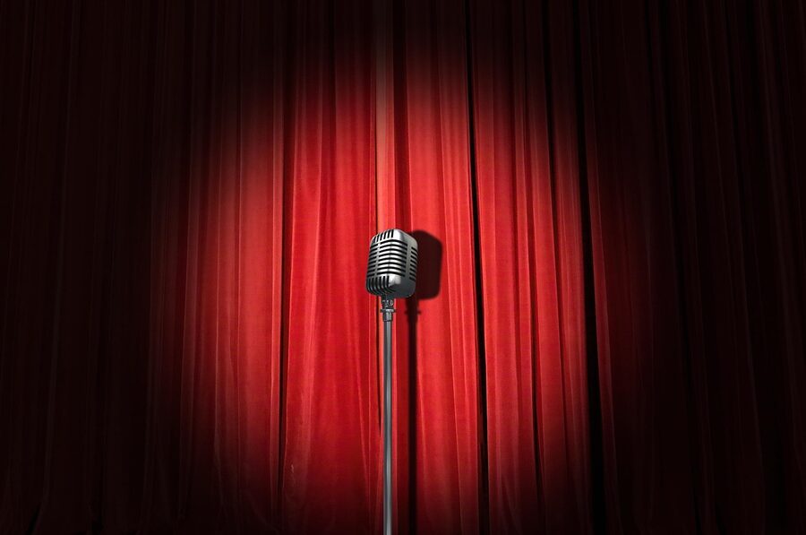 Stand-up comedy stage with curtain and microphone