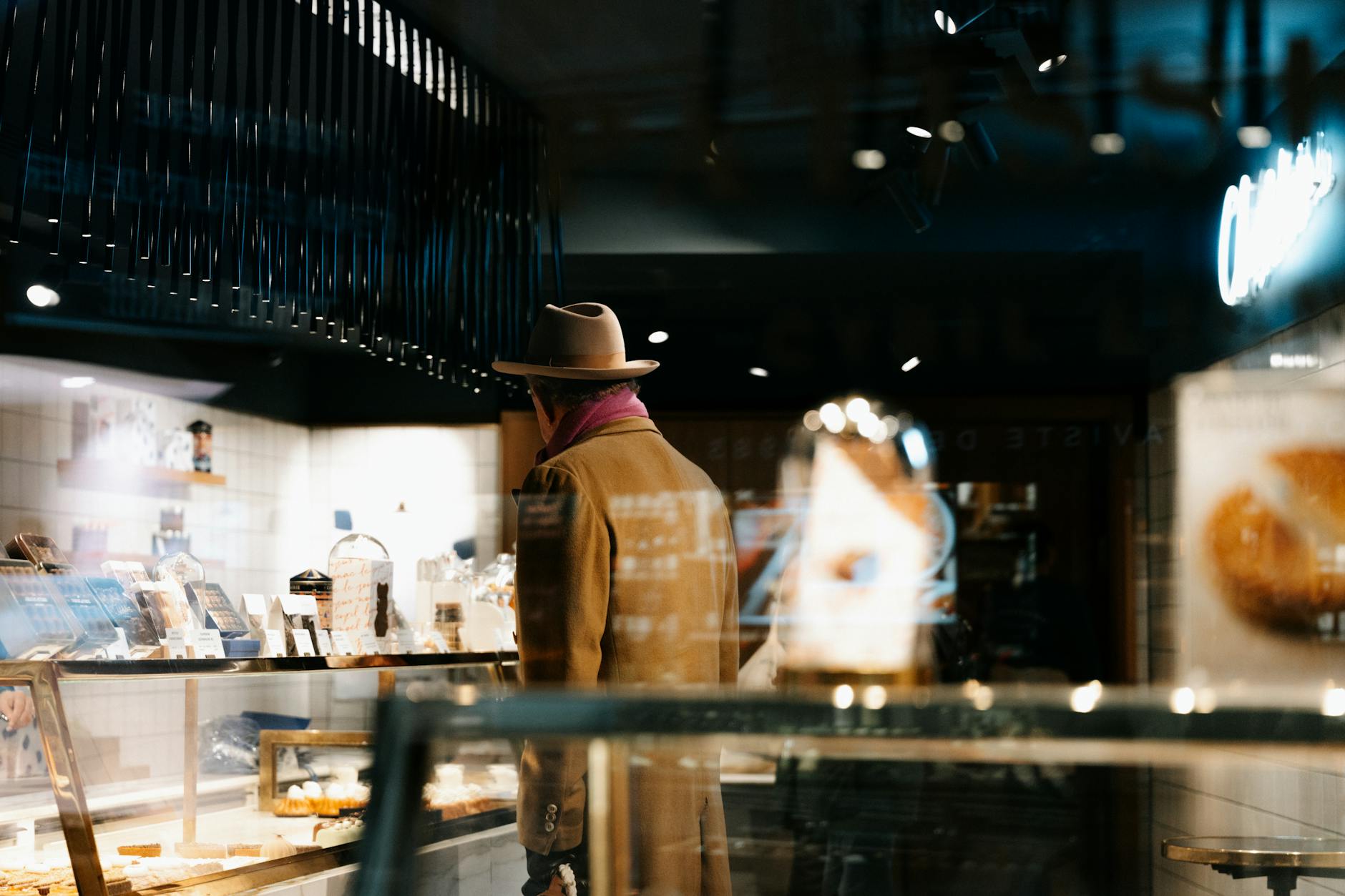 Stylish man choosing pastries at a Paris bakery counter