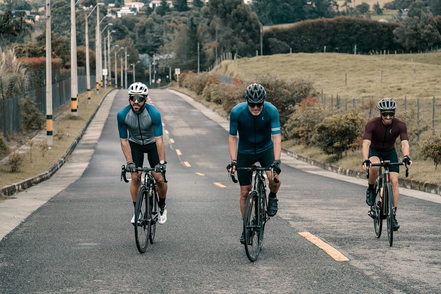 Three cyclists on a scenic rural road