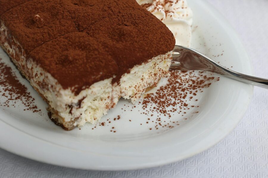 Tiramisu with cocoa on white plate