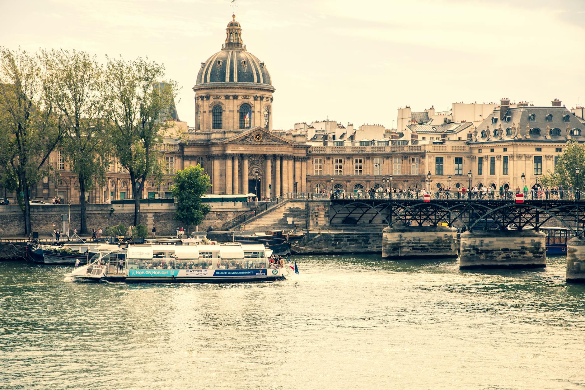 A tourist boat on the Seine river with the Institut de France building in the background