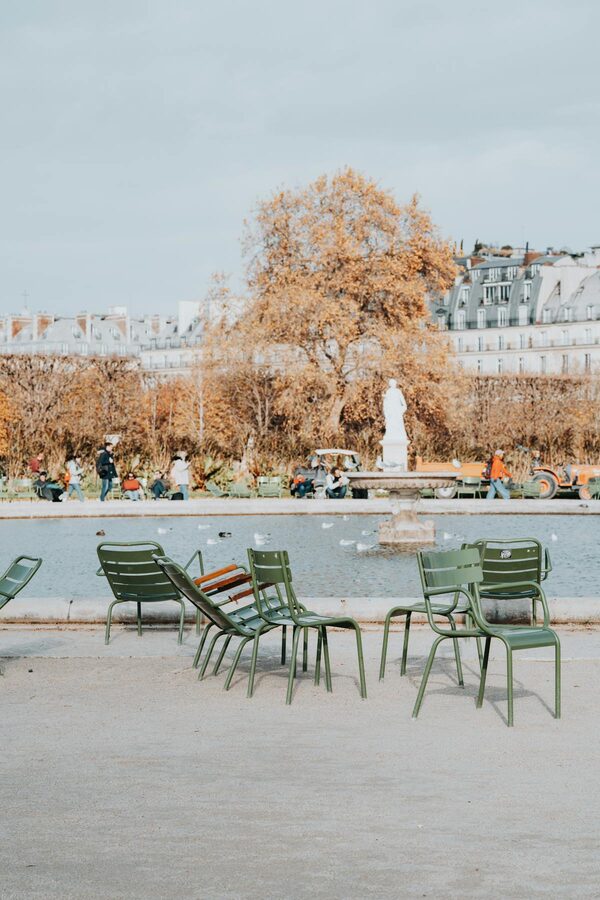 Chairs beside a fountain in Tuileries Garden Paris in autumn