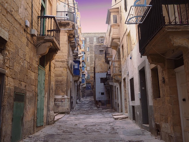 Quiet limestone alley in Valletta with traditional architecture