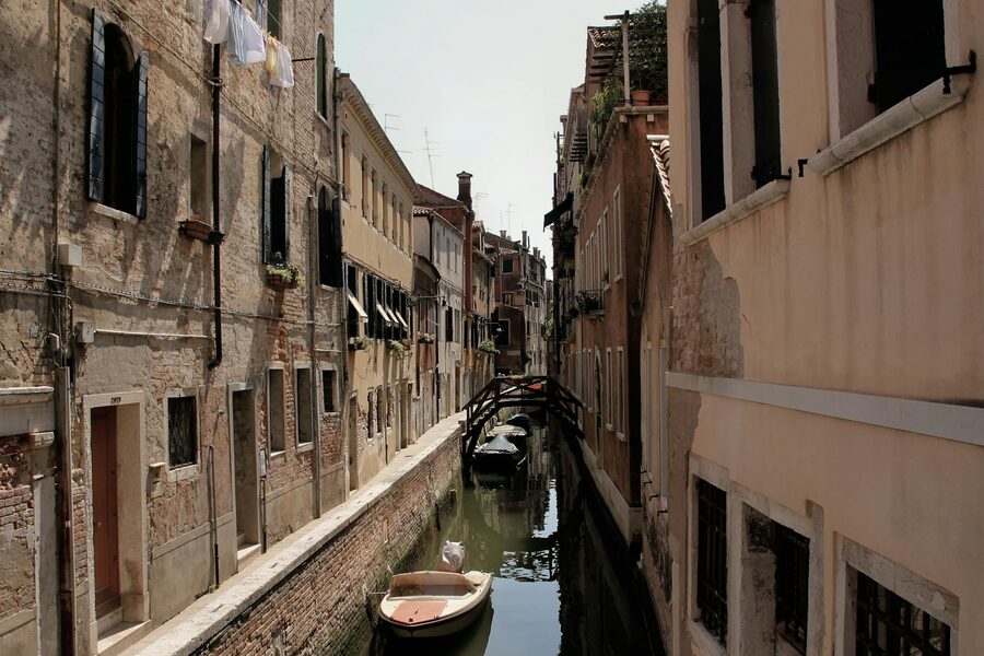 Venice canal with a small boat and historic buildings