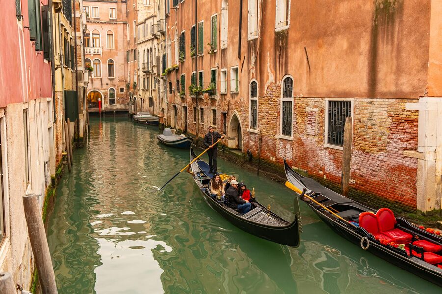 Gondolas on a Venetian canal surrounded by historic architecture
