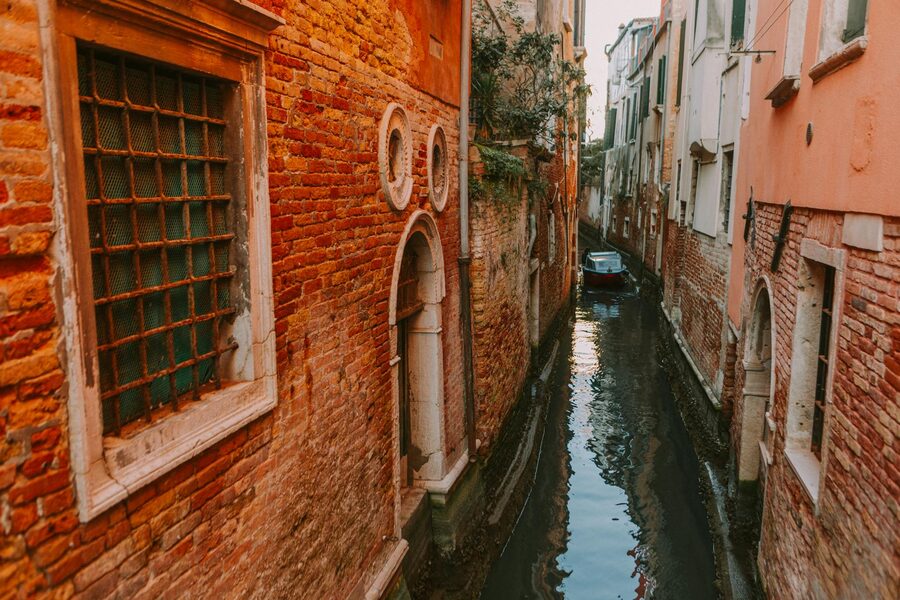 Narrow Venice canal with historical brick architecture