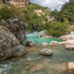 Turquoise river cutting through limestone cliffs in the Gorges du Verdon