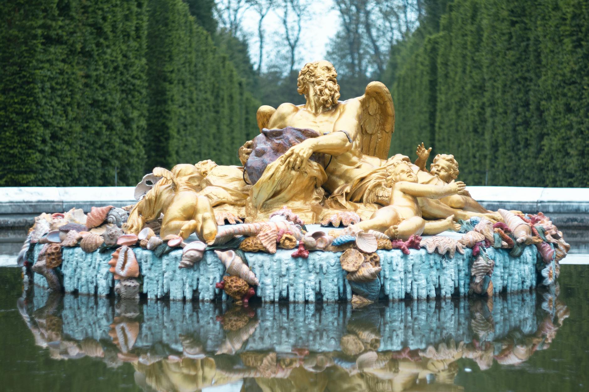 The Saturn Fountain at Versailles with golden statues and cherubs