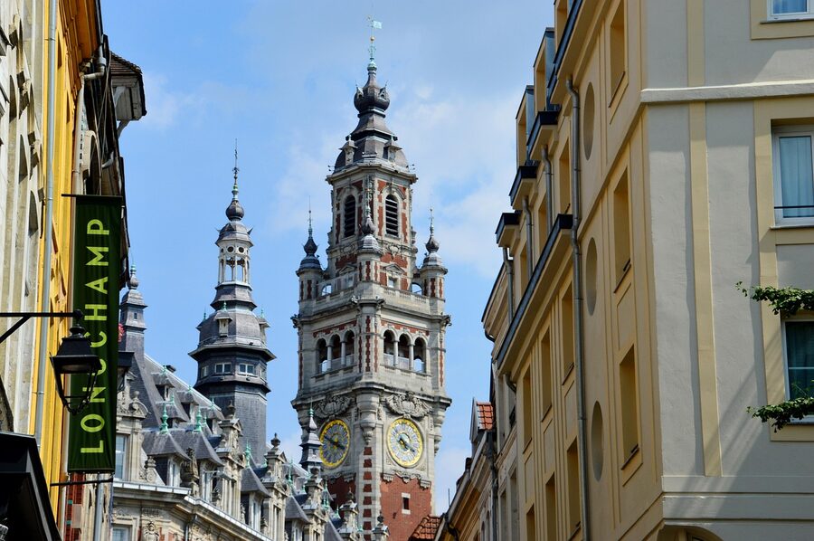 Flemish architecture street in Vieux Lille with belfry tower visible
