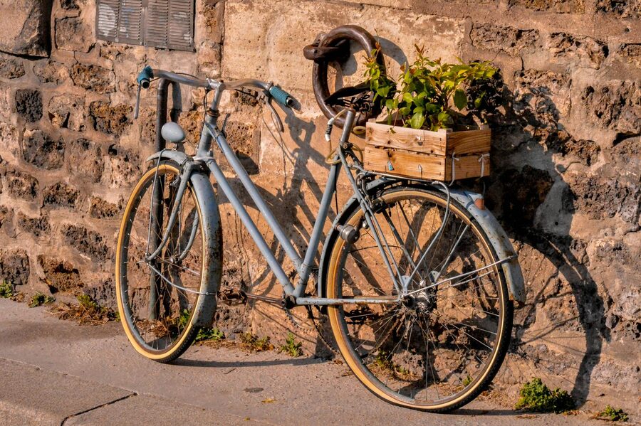 Vintage-style bicycle leaning against a stone wall in Paris