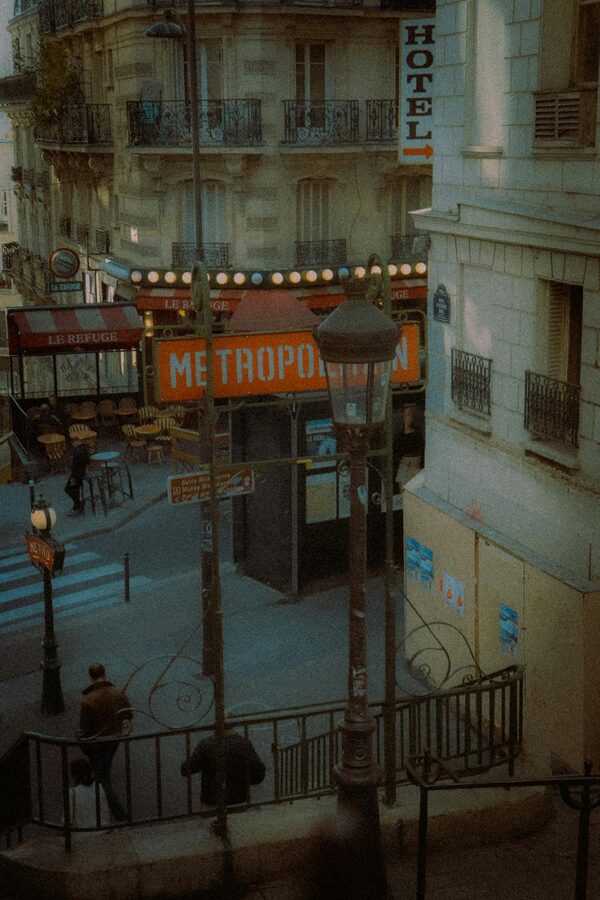 Vintage view of a Paris street with a metro sign and classic architecture