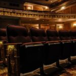Vintage theater interior with ornate decor and plush seating