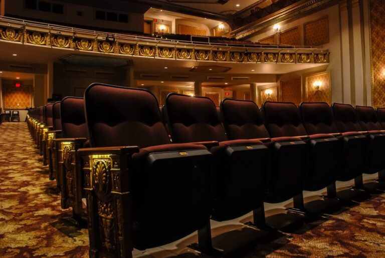 Vintage theater interior with ornate decor and plush seating