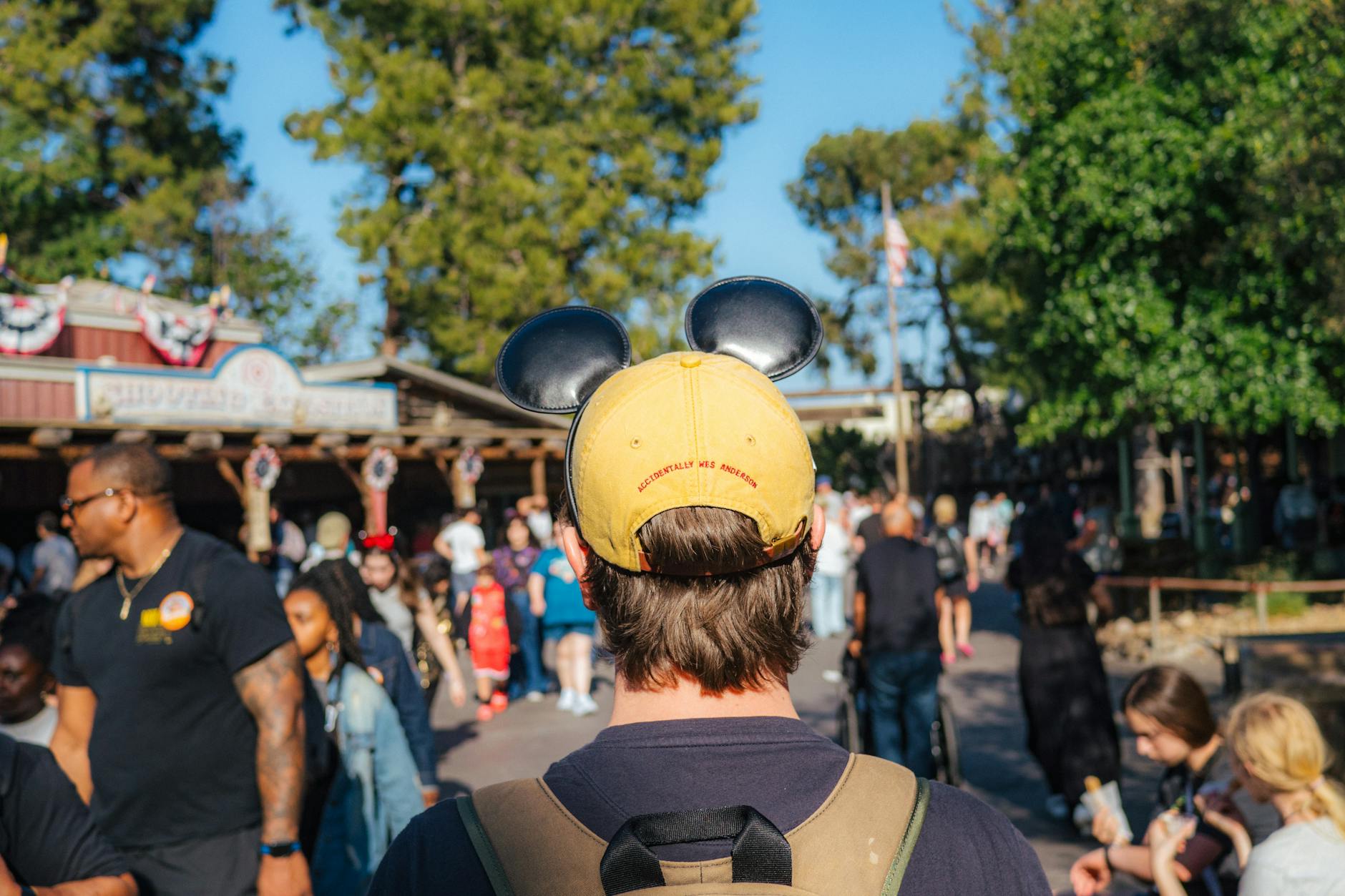 Visitor wearing Mickey ears at a Disney park