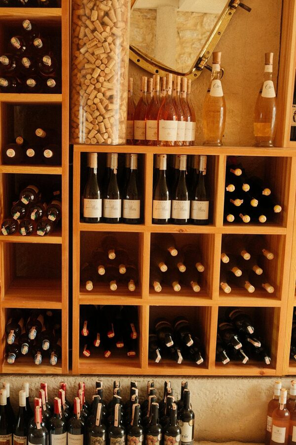 Wine bottles stored in a wooden rack in a cellar