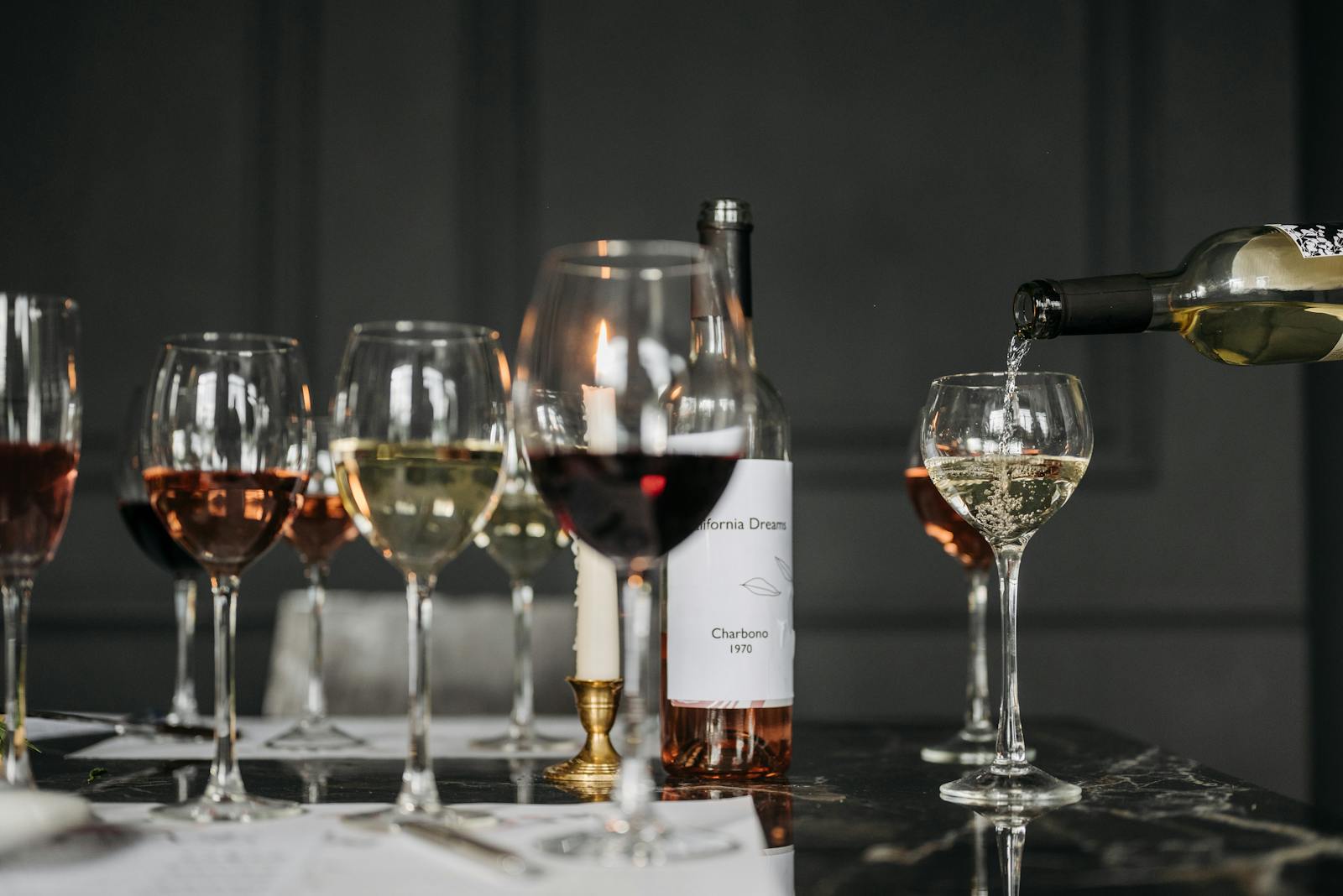 Sophisticated wine tasting arrangement with multiple glasses on a dimly lit table