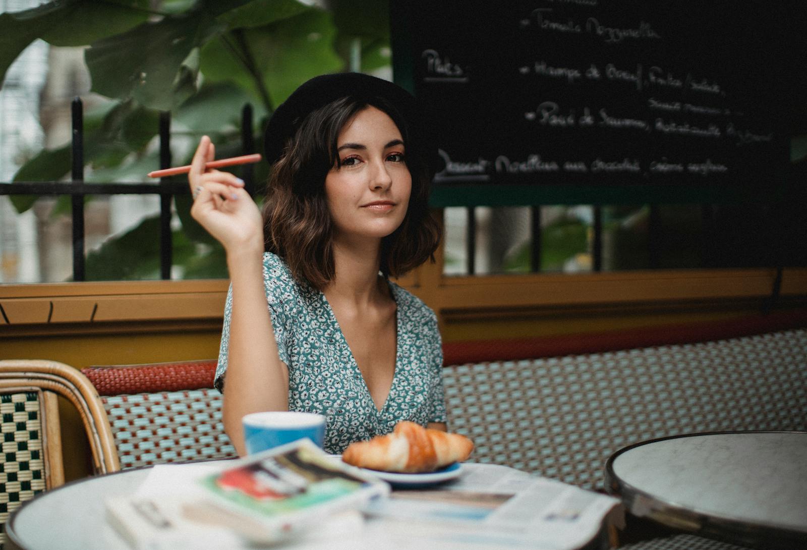 Woman in a beret enjoying coffee at a Paris sidewalk café