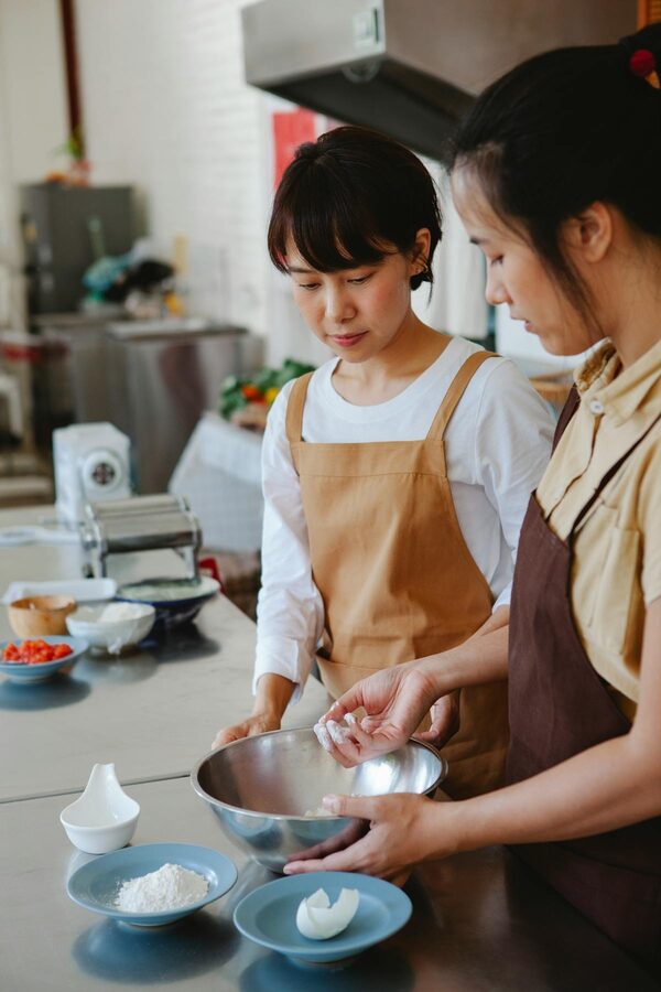 Two people baking together in a modern kitchen