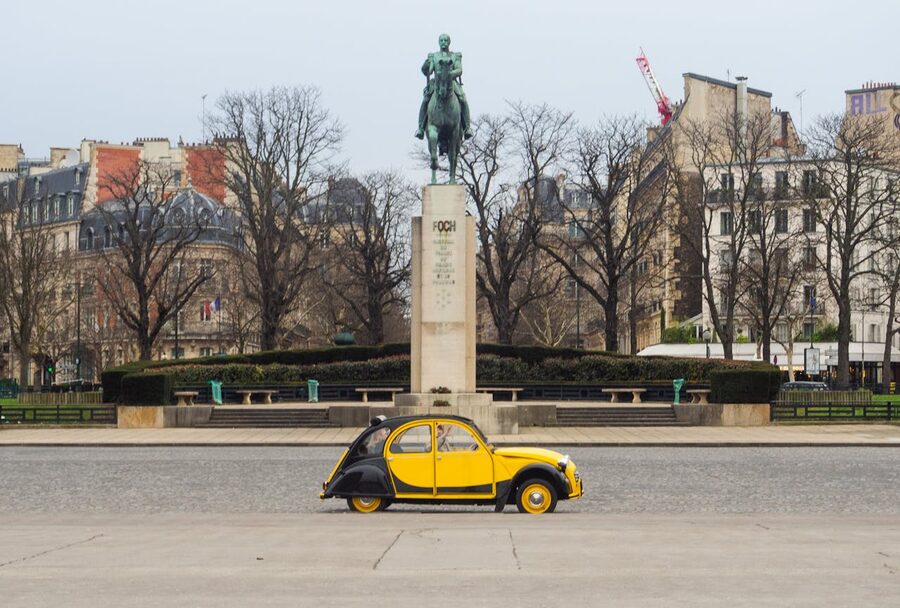 Yellow Citroen 2CV near the Foch Monument in Paris