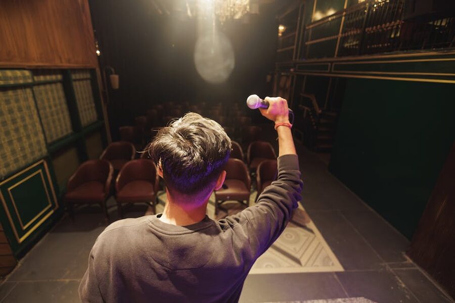 Young comedian preparing to perform on stage