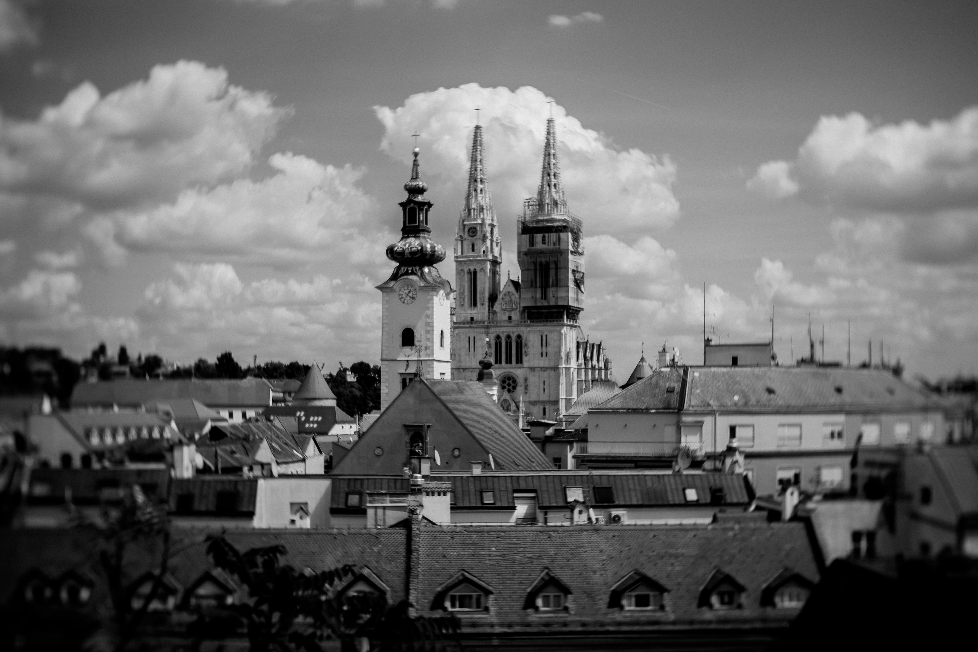 Black and white photo showcasing Zagreb Cathedral with cloudy sky in the background