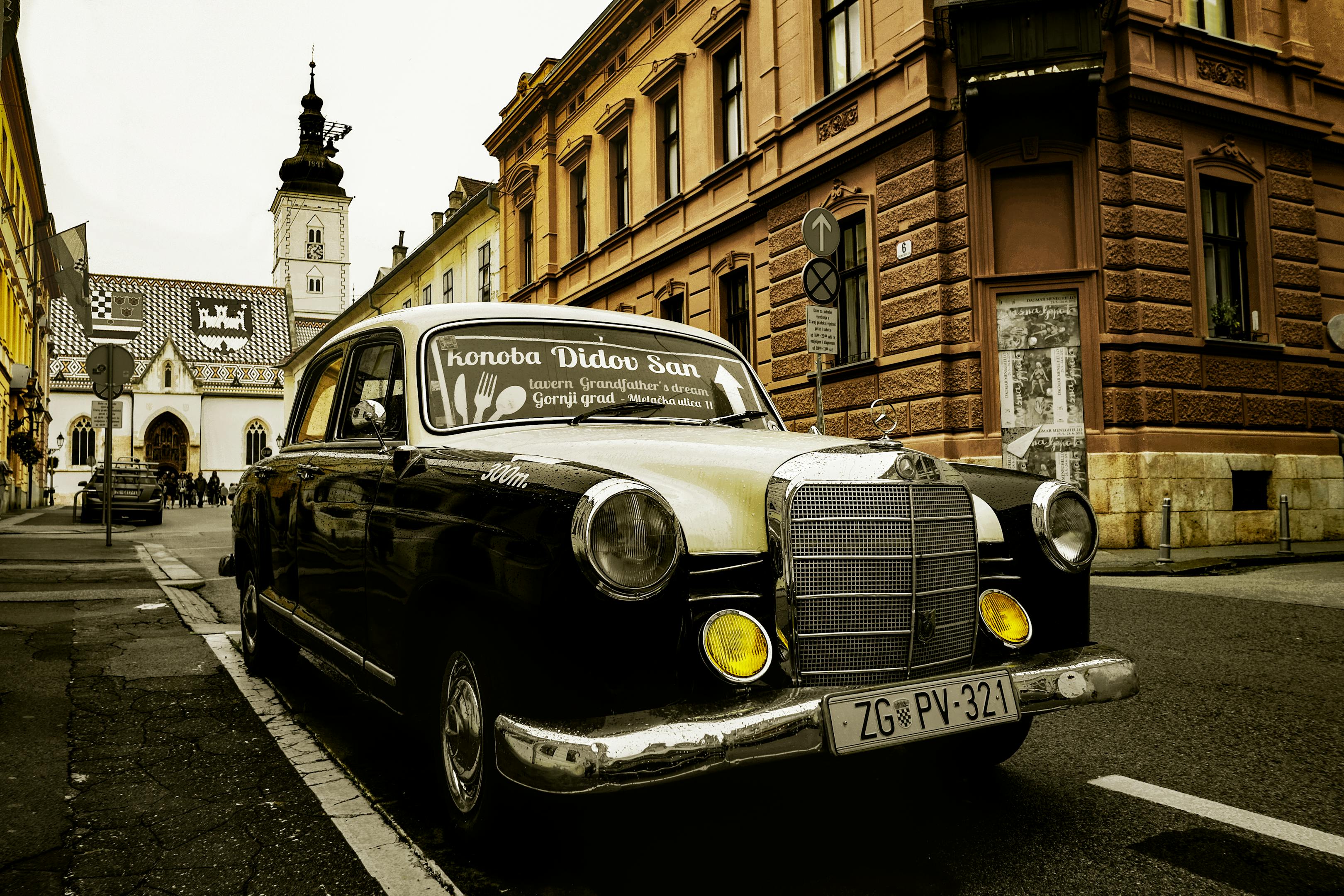Classic Mercedes car in front of iconic St. Mark's Church, Zagreb