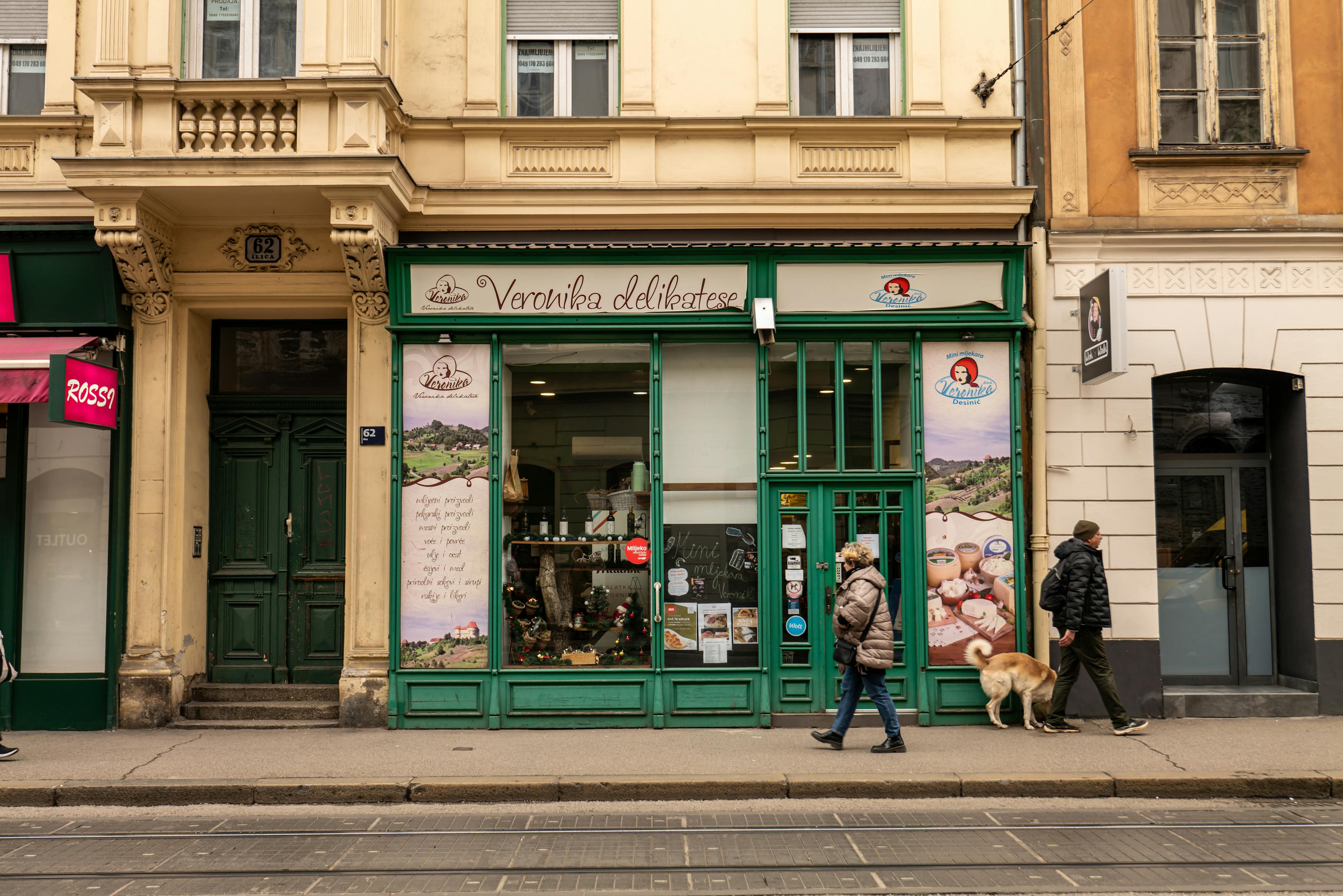 Street view of Veronika delicatessen shop with pedestrians passing in Zagreb, Croatia
