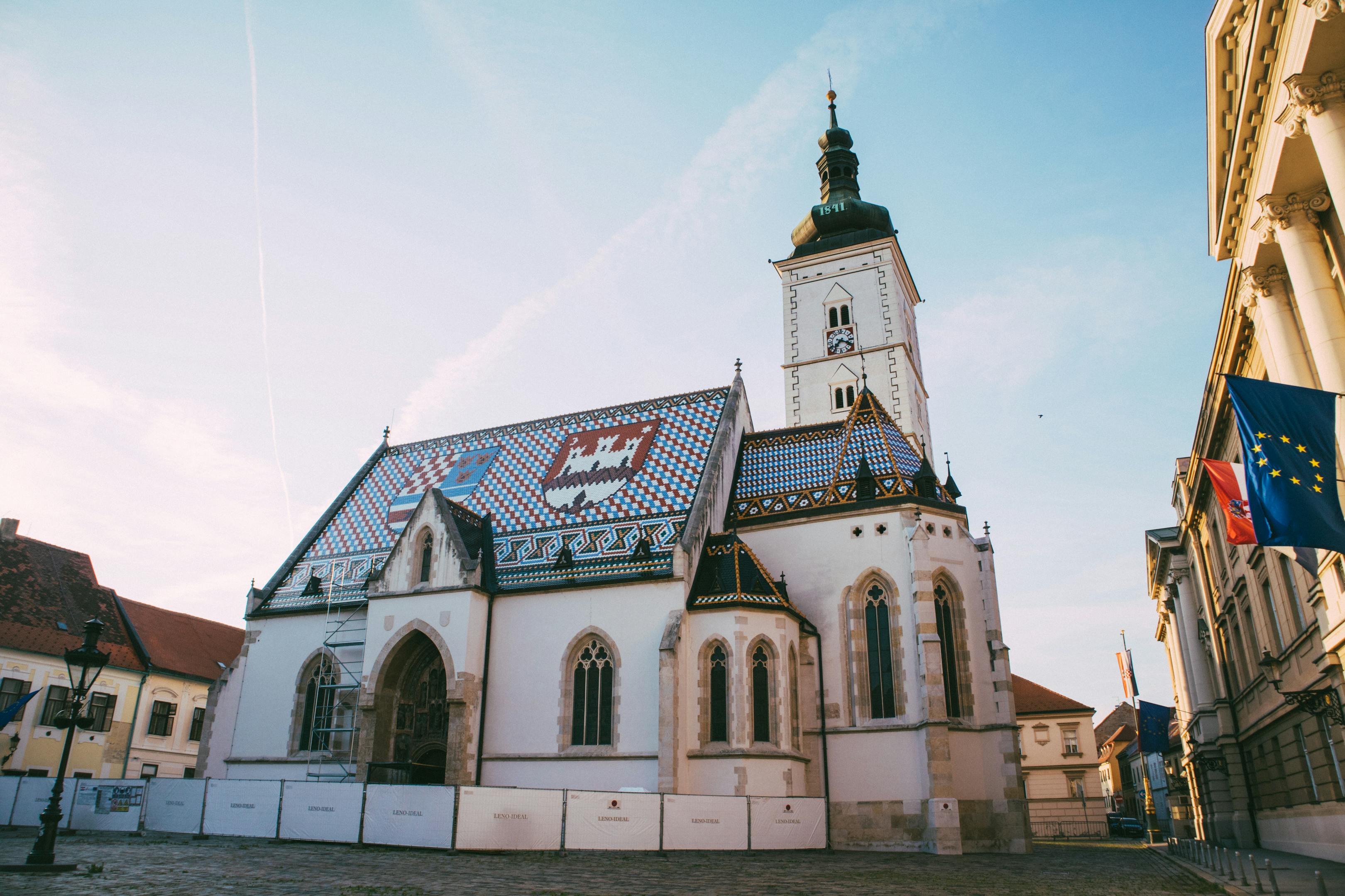 Beautiful view of St. Mark's Church and Town Square in Zagreb, Croatia under a clear blue sky