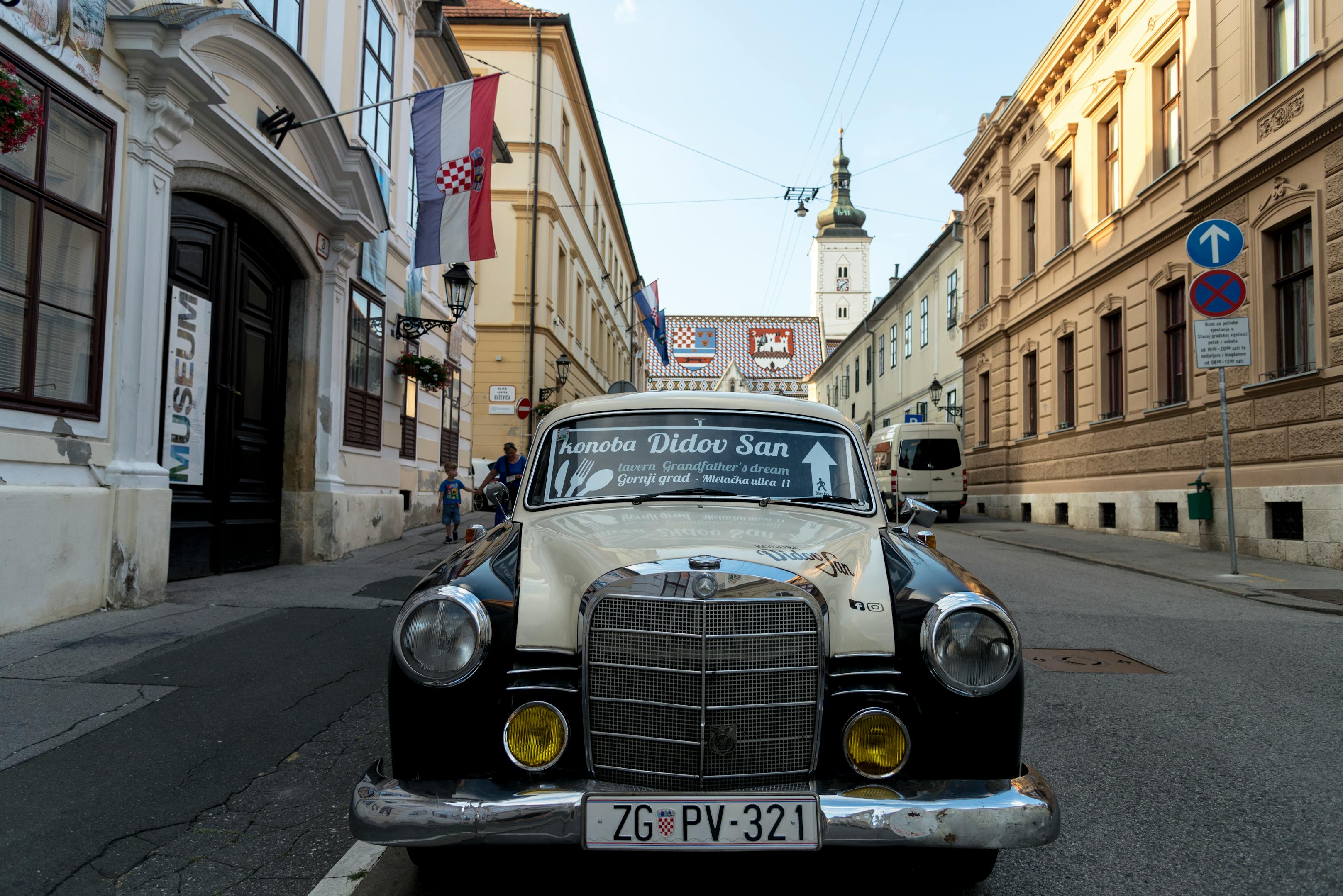 Vintage car on a quaint street in Zagreb, highlighting local architecture and culture